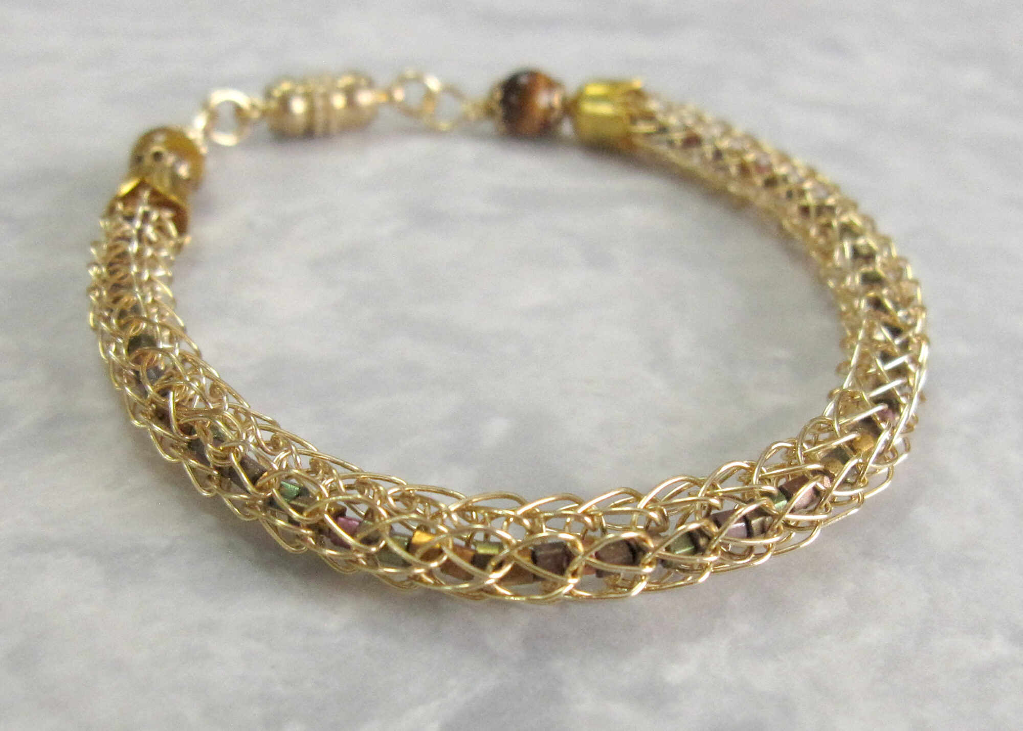 Gold Viking Knit Bracelet Filled With Metallic Seed Beads and Finished with Tiger's Eye Beads and a Magnetic Catch