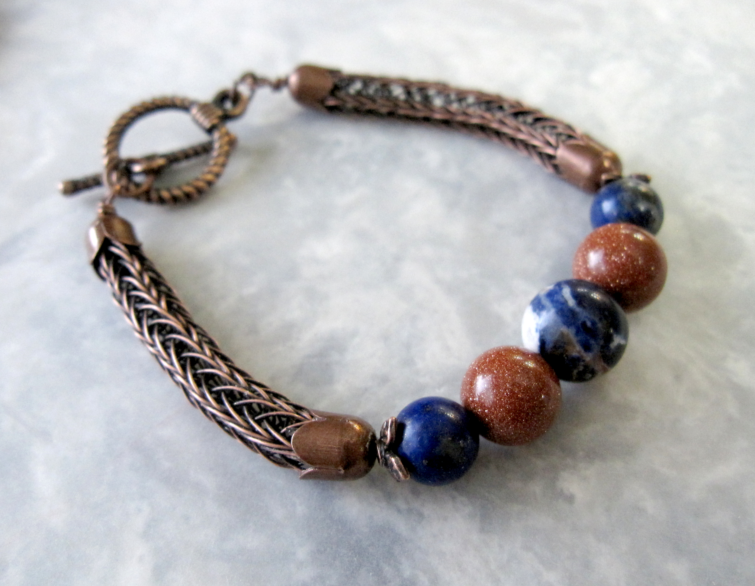 Lapis Lazuli, Sodalite, and Goldstone Beads set in a Double Viking Knit bracelet