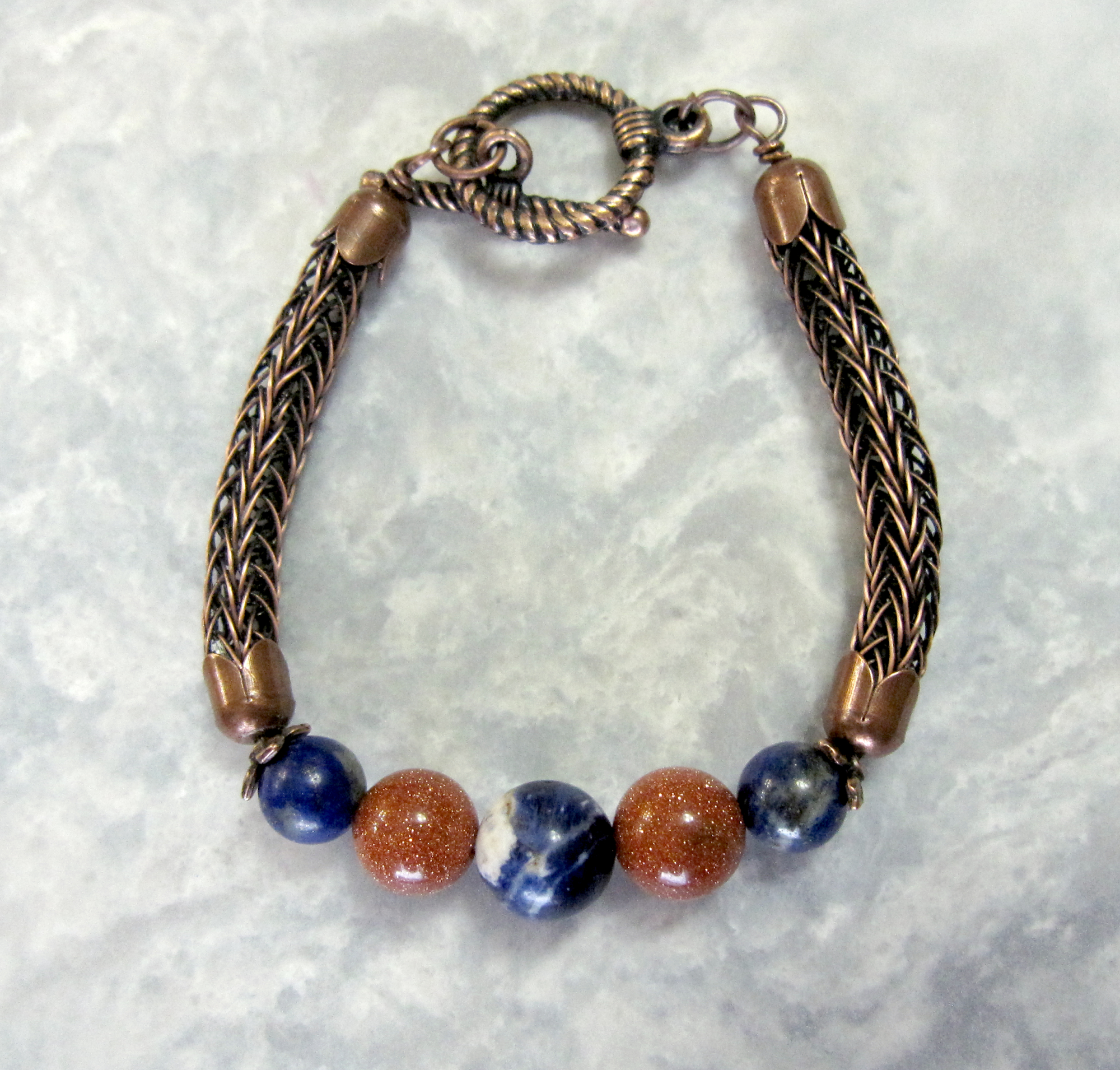 Lapis Lazuli, Sodalite, and Goldstone Beads set in a Double Viking Knit bracelet