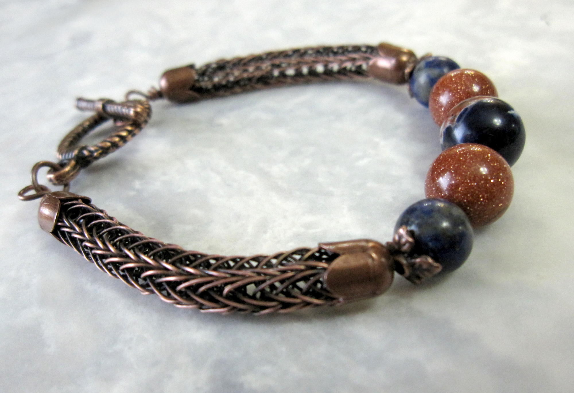 Lapis Lazuli, Sodalite, and Goldstone Beads set in a Double Viking Knit bracelet